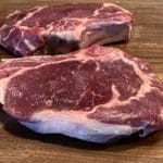 Two aged grass-fed bone-in ribeye steaks